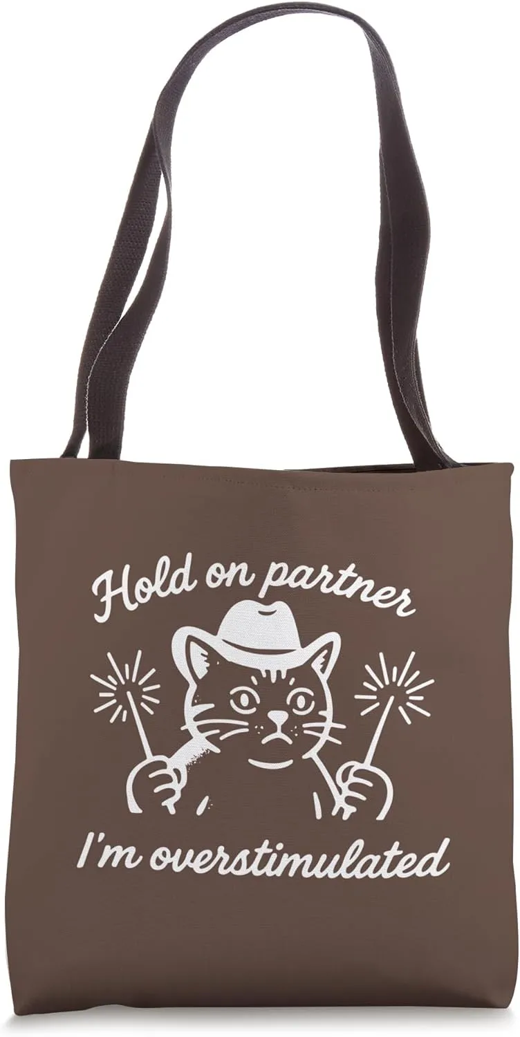 HOLD ON PARTNER I'M OVERSTIMULATED - Cat holding sparklers Tote Bag